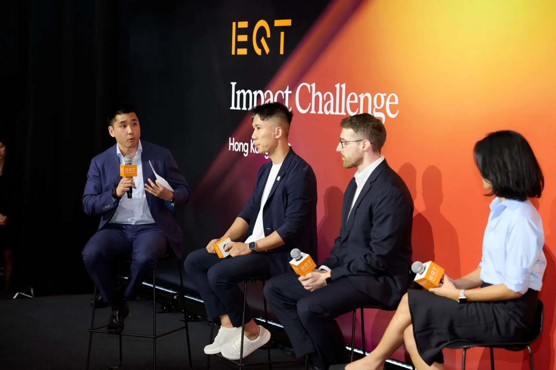 Michael Brenndoerfer speaking on AI value creation at the EQT Impact Challenge in Hong Kong